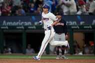 Texas Rangers' Corey Seager runs the bases past Cleveland Guardians' Josh Naylor, rear,...
