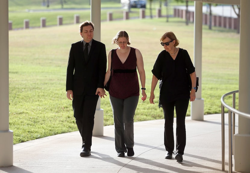 Defendant Michael Thedford walks into the Collin County Courthouse while holding hands with...