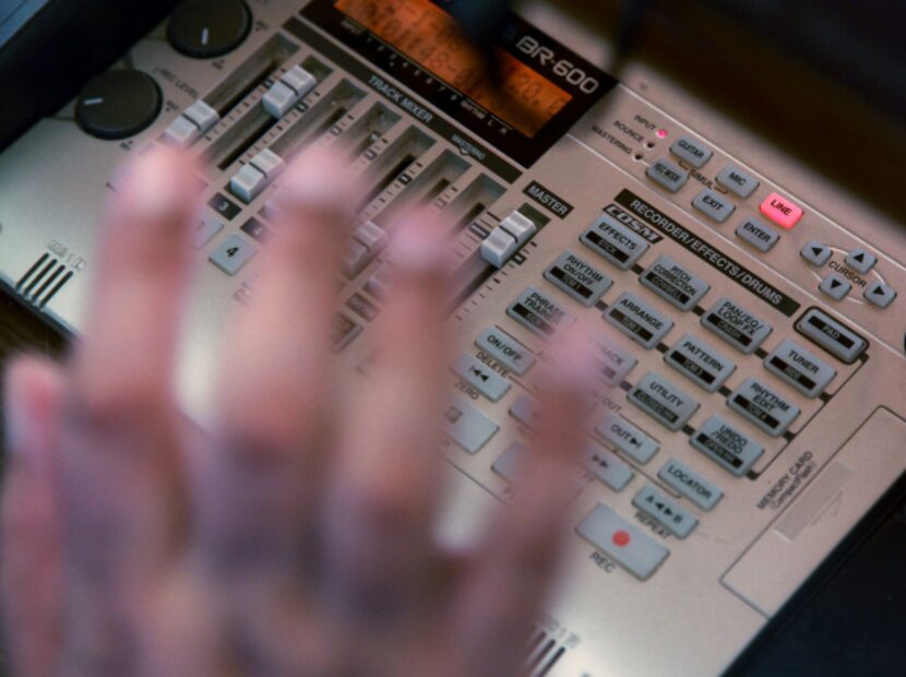 Mike Tamez of Irving slaps at his synthesizer while laying down tracks for his radio sports...