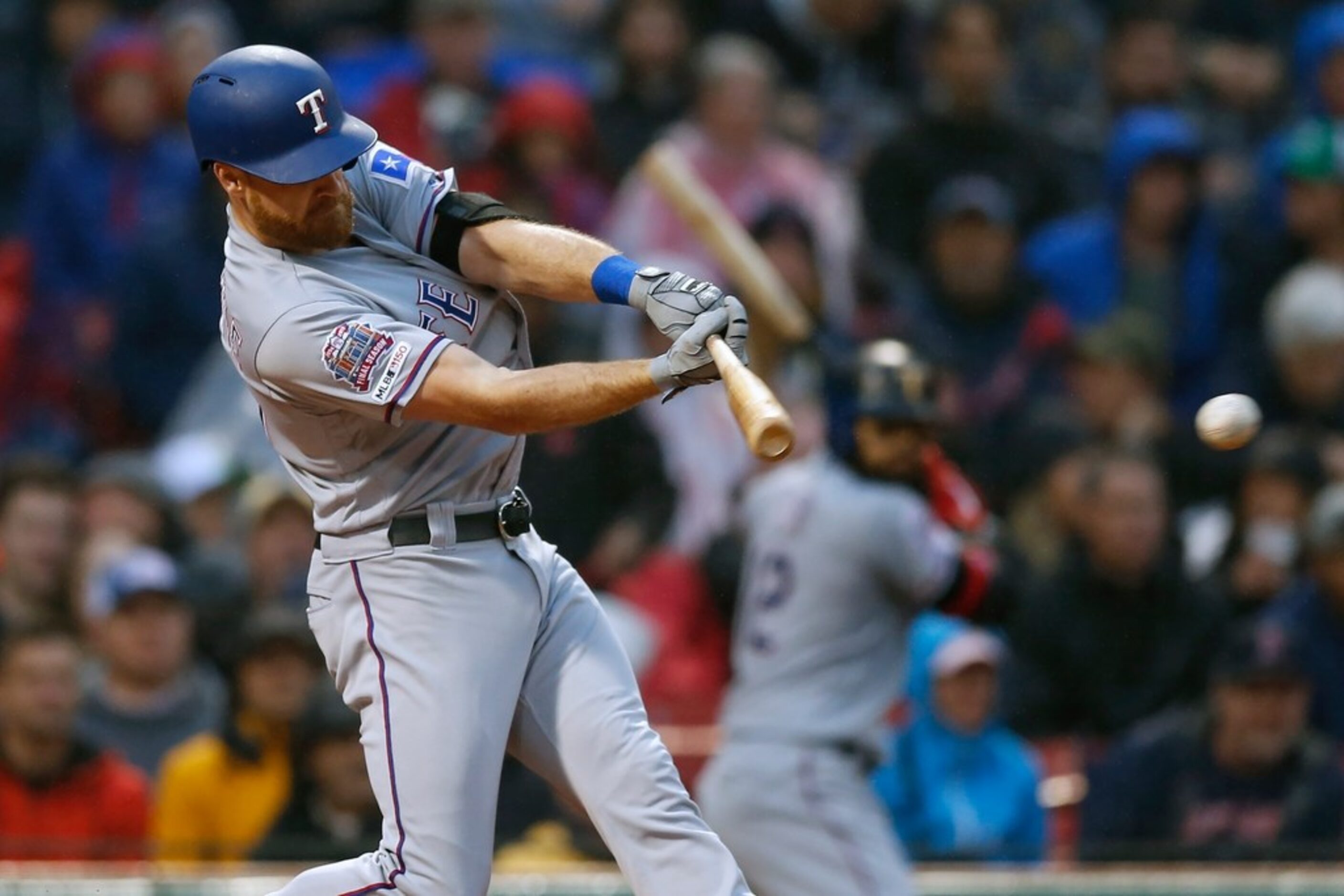 Texas Rangers' Logan Forsythe hits a two-run single during the first inning of the team's...