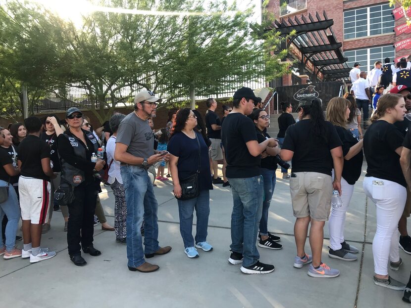 People wait to enter the ballpark shortly before the memorial got under way.