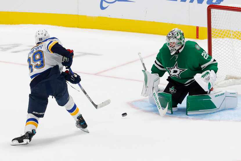 Dallas Stars goaltender Jake Oettinger (29) stops a shot from St. Louis Blues left wing...