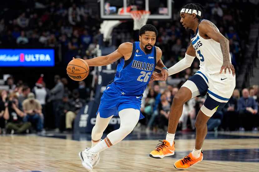 Dallas Mavericks guard Spencer Dinwiddie (26) works toward the basket while defended by...