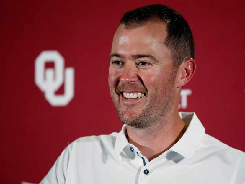 Oklahoma head coach Lincoln Riley smiles as he answers a question during an NCAA college...