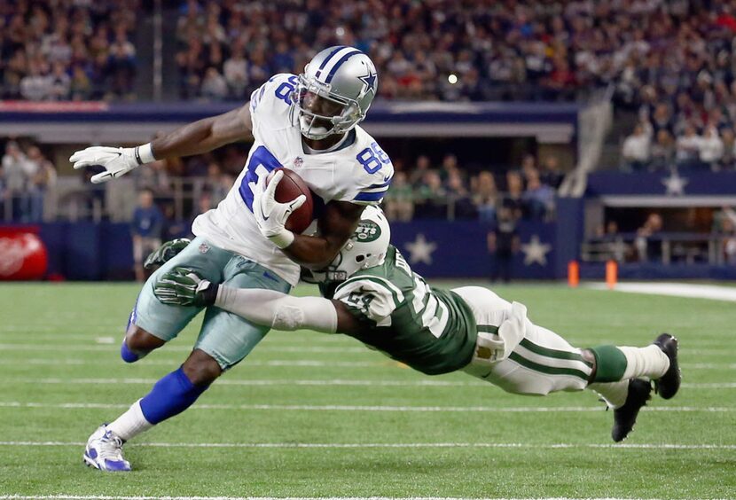 ARLINGTON, TX - DECEMBER 19:   Dez Bryant #88 of the Dallas Cowboys carries the ball and...