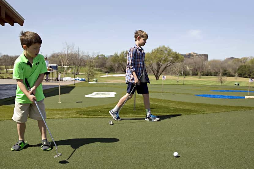 William Grimsley (left), 7, and his 11-year-old brother, Evan, check out a new miniature...