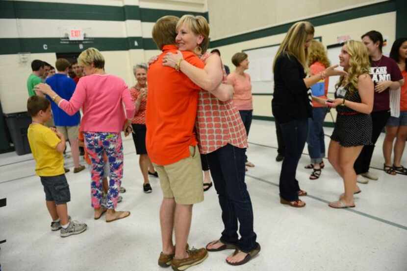 
Fifth-grade teacher Melanie Willett hugs former student and graduating senior Ryan O'Dell...