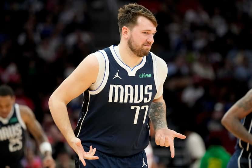 Dallas Mavericks guard Luka Doncic gestures after making a 3-point basket against the...