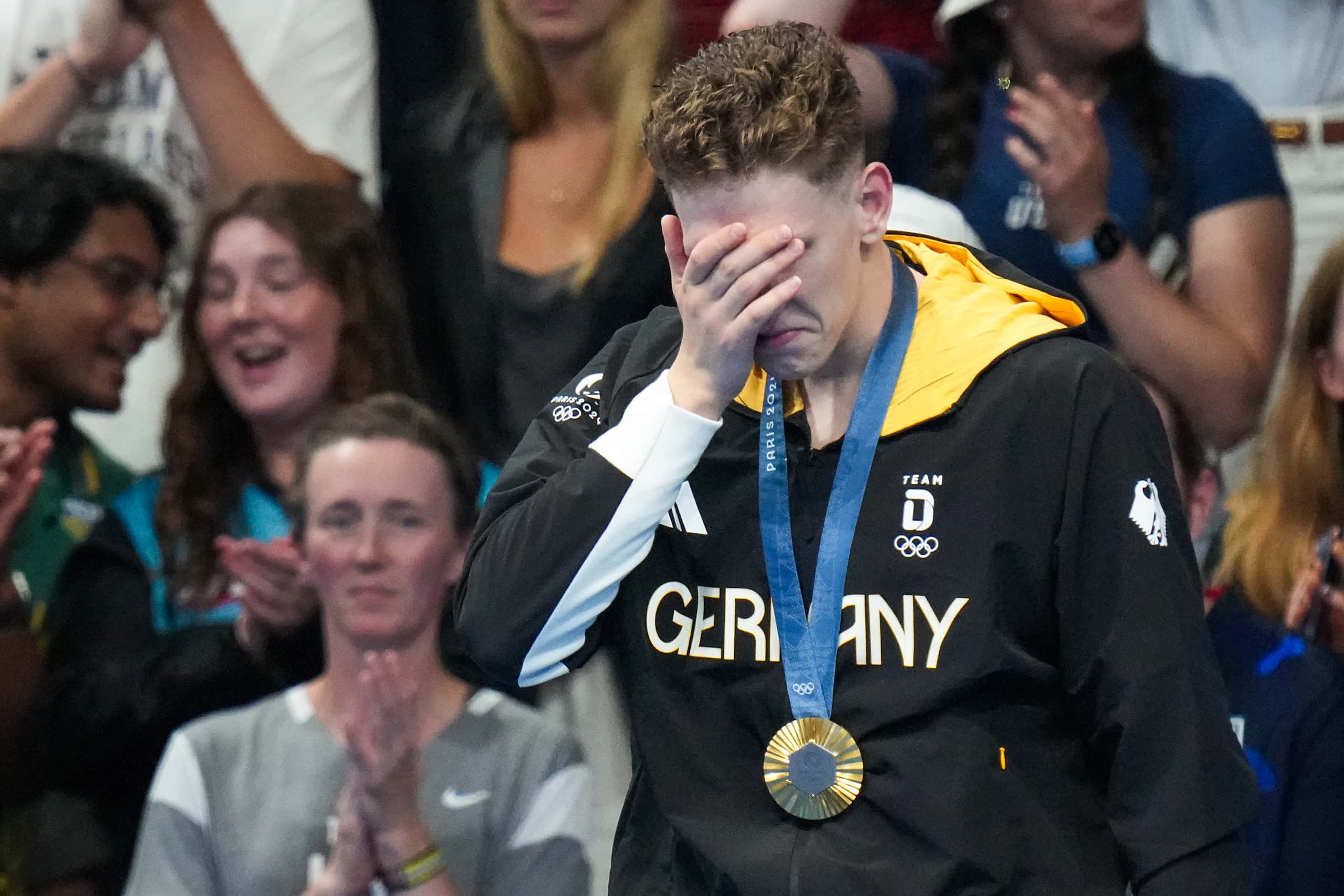 Lukas Maertens of Germany reacts on the podium after winning the men's 400-meter freestyle...