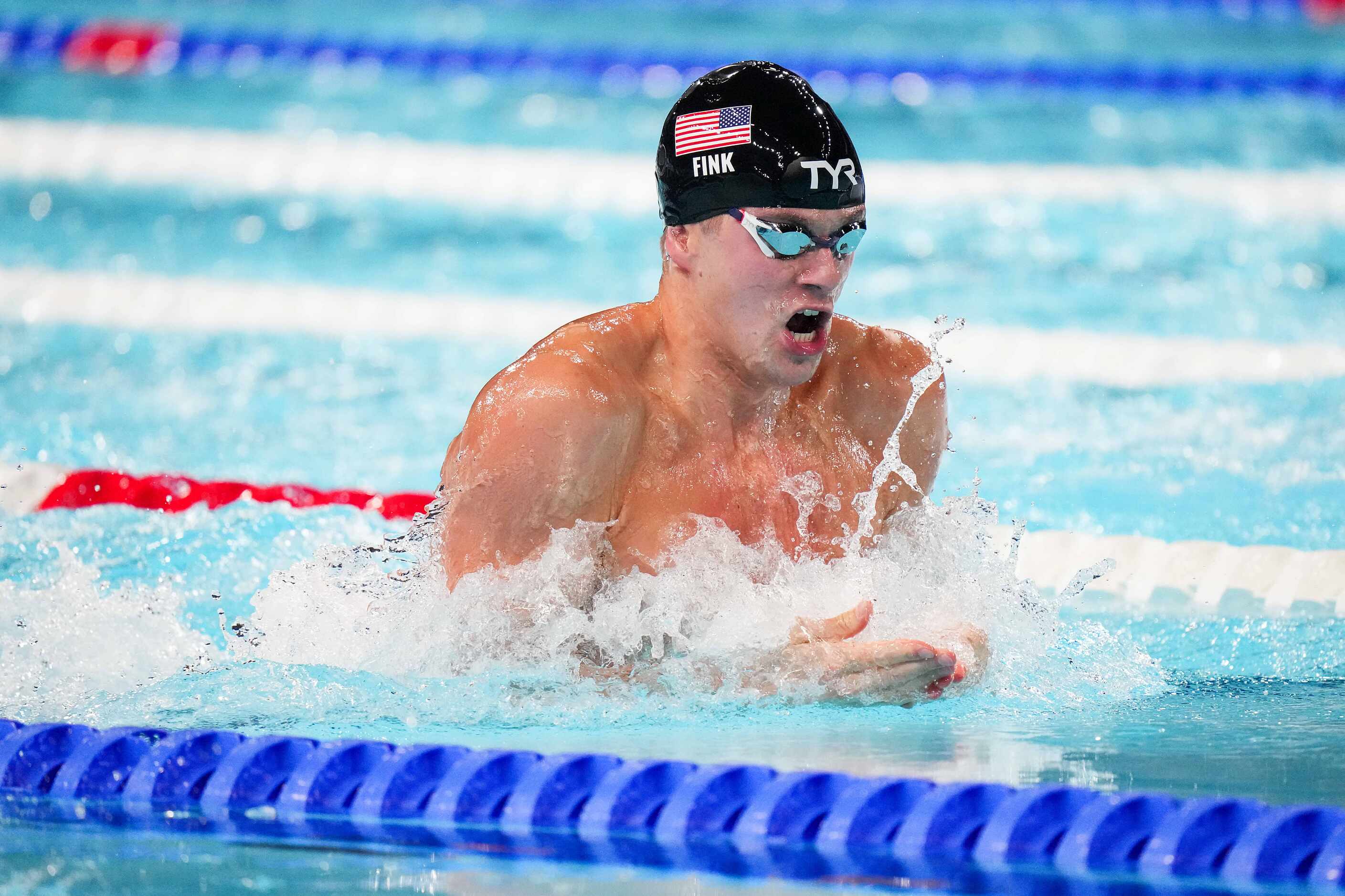 Nick Fink of the United States swims in the men's 100-meter breaststroke final at the 2024...