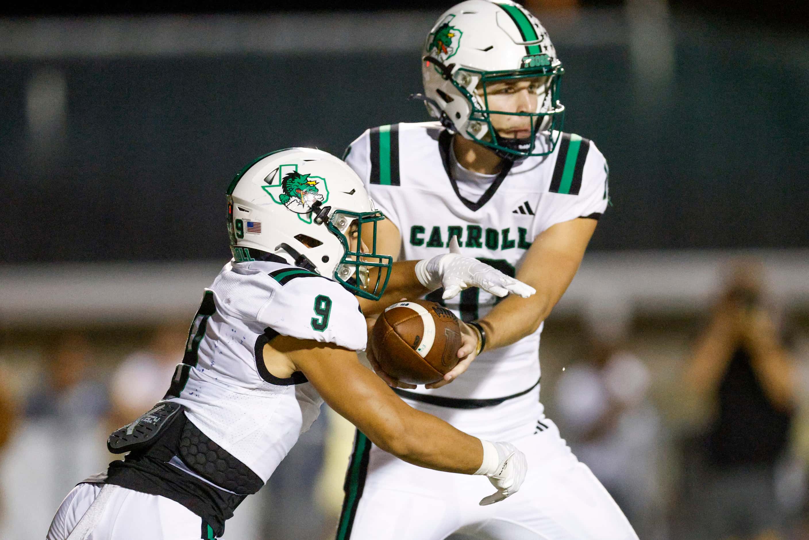 Southlake Carroll quarterback Graham Knowles (10) hands the ball to running back Riley...