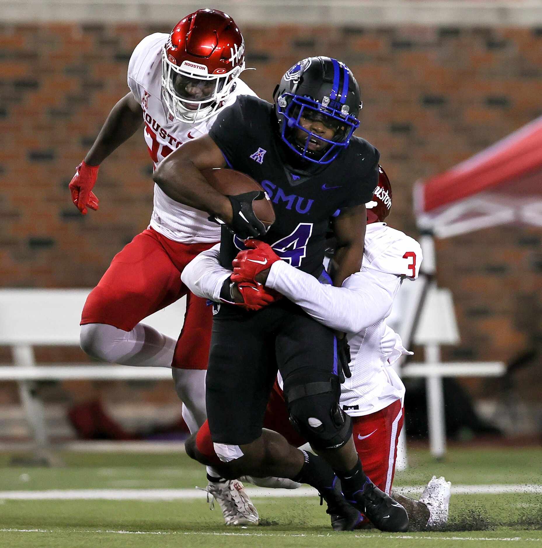SMU running back Velton Gardner (24) makes a nice run and is brought down by Houston...