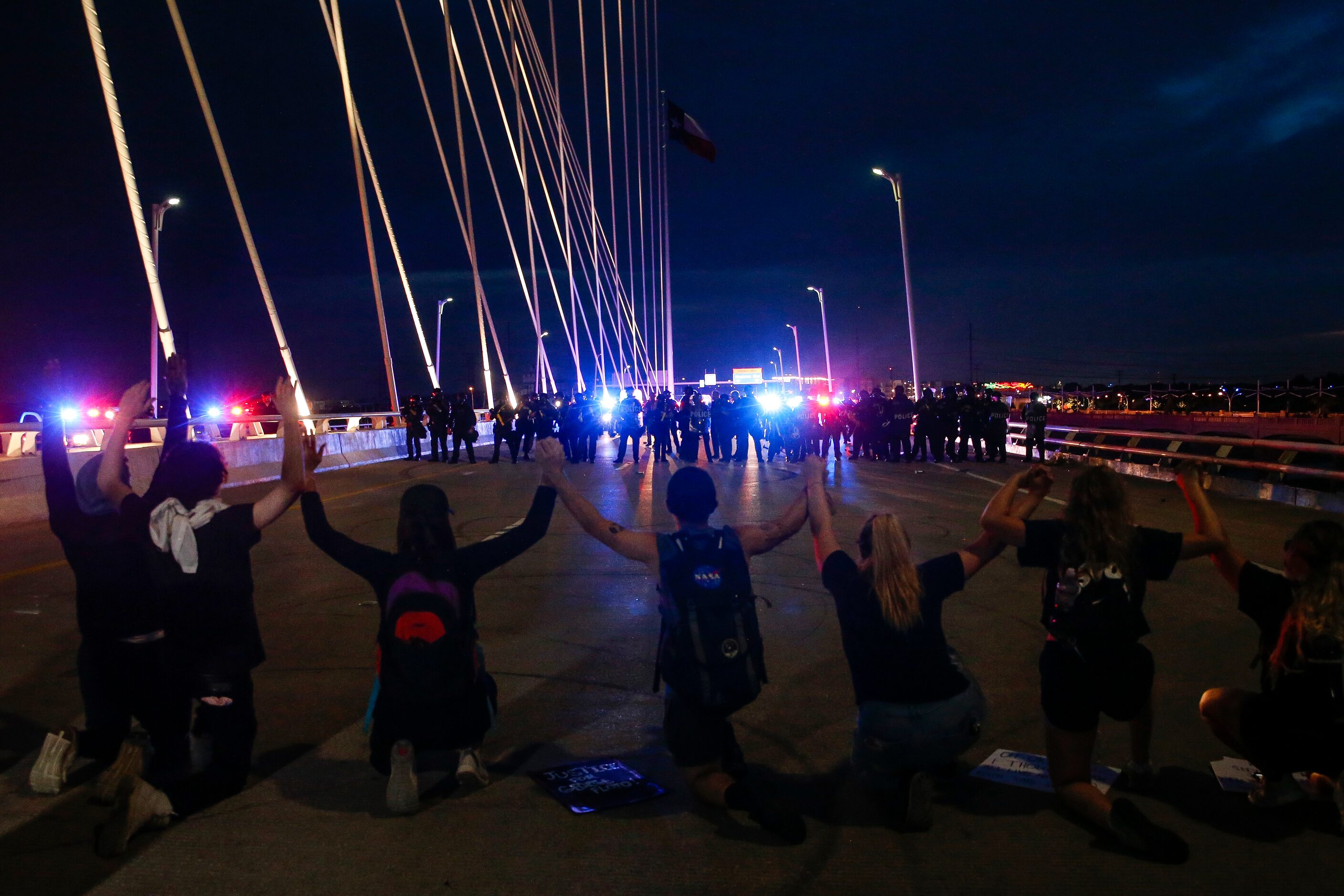 Protesters march onto the Margaret Hunt Hill Bridge as the demonstrate against police...