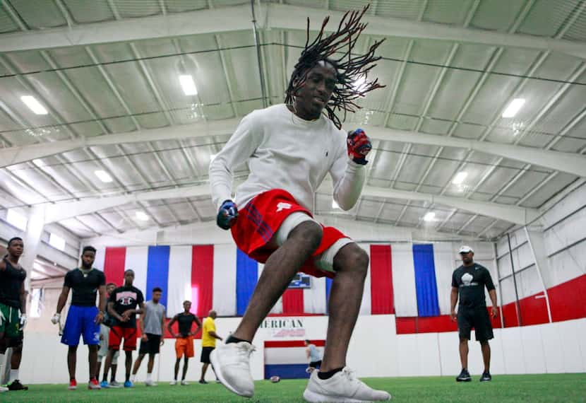 Mesquite High School defensive back Antonio Taylor, 17, works on his foot technique with...