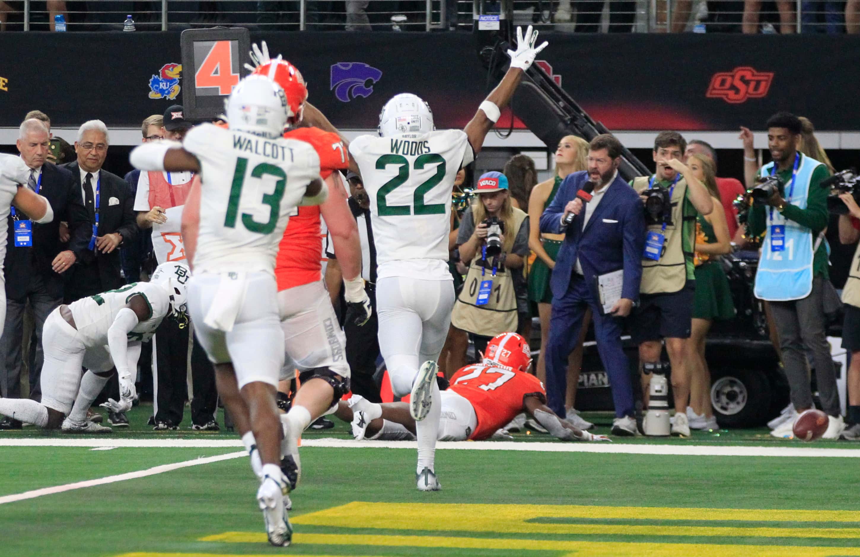 The football rolls away, and Baylor Bears safety JT Woods (22) celebrates, as Oklahoma State...