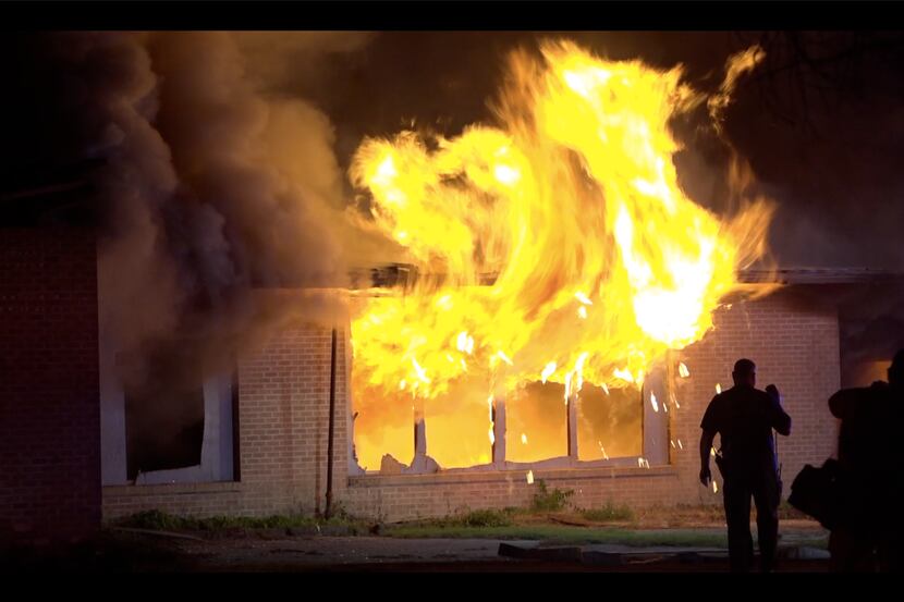 Flames shoot through the windows of the original Dallas Christian Academy Building on...