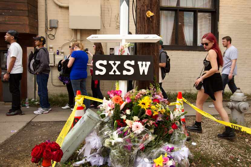 File - In this March 15, 2014 file photo, a cross and flowers are outside The Mohawk in...
