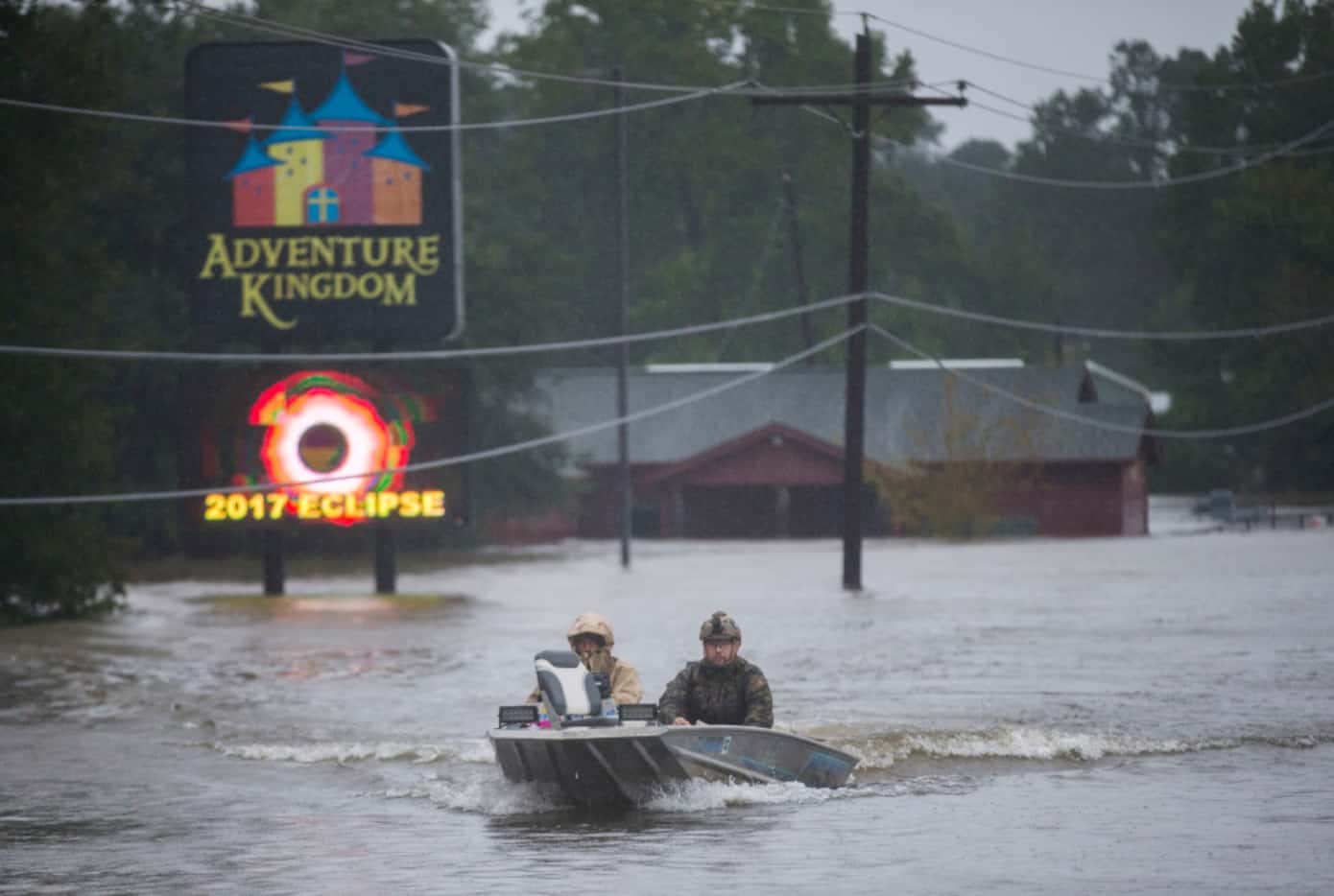 Emergency responders drive a boat across Highway 96 in floodwaters in Lumberton.