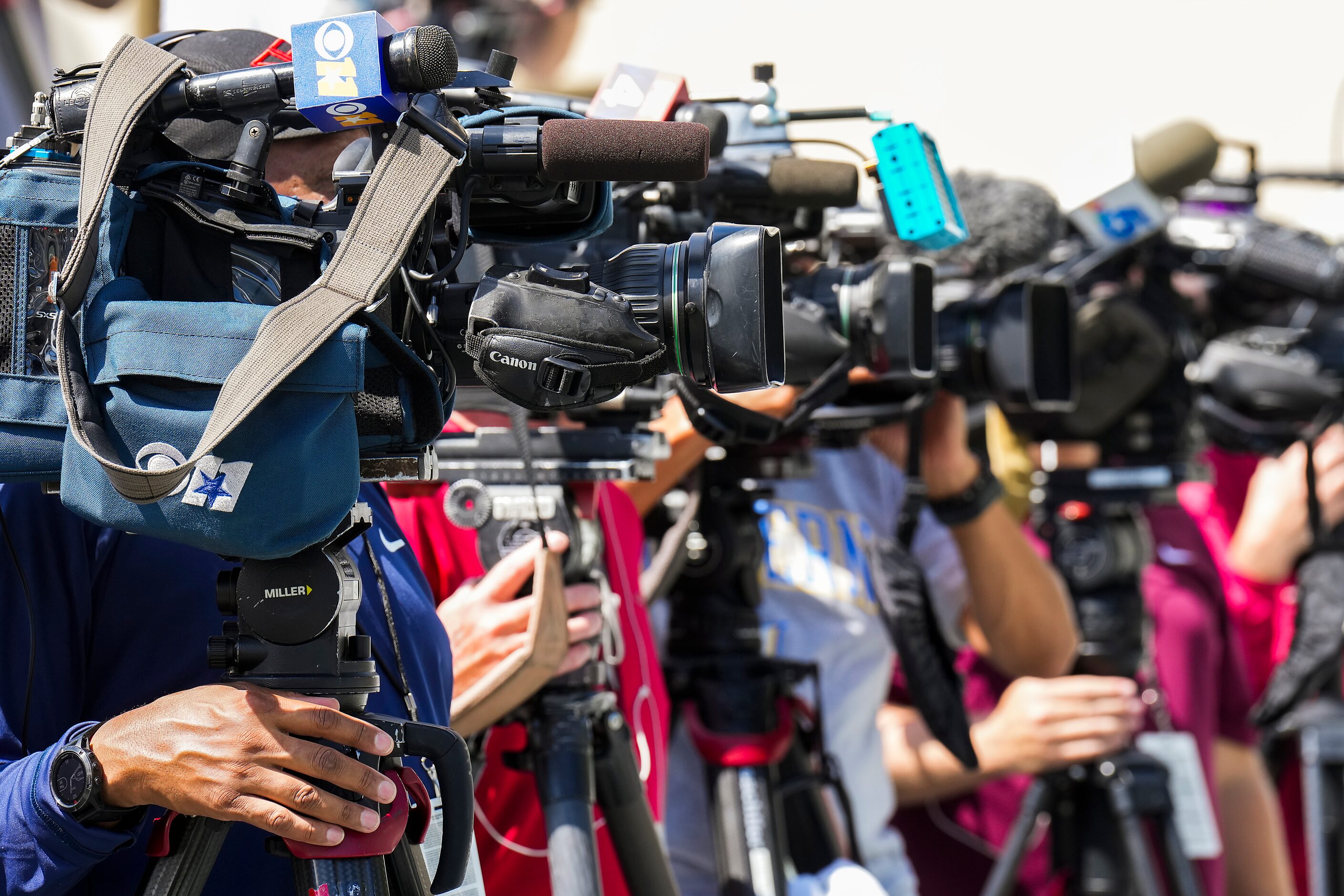 Cameras are trained on a Dallas Cowboys pre-training camp news conference with Jerry Jones,...