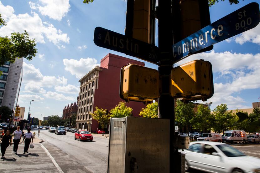 Pedestrian and vehicle traffic moves down Commerce Street near Austin Street on Thursday,...