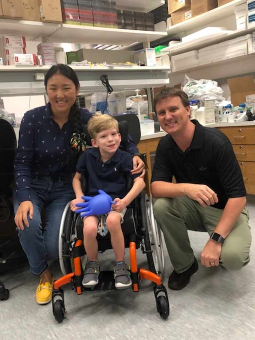 Will Woleben, 6, of McKinney visits with UT Southwestern Medical Center researchers Steven...