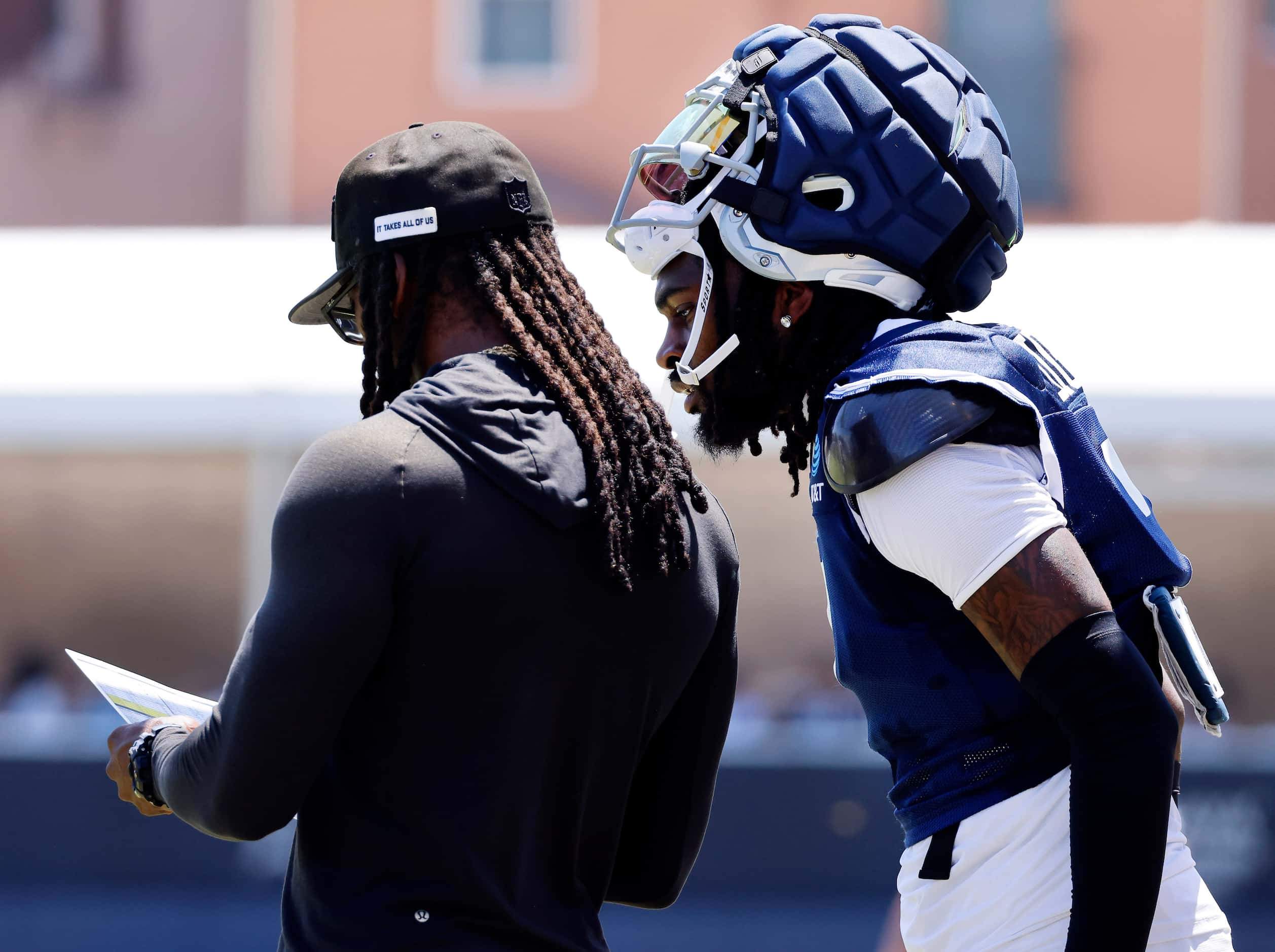 Dallas Cowboys cornerback Trevon Diggs (7) looks over the shoulder of defensive back coach...