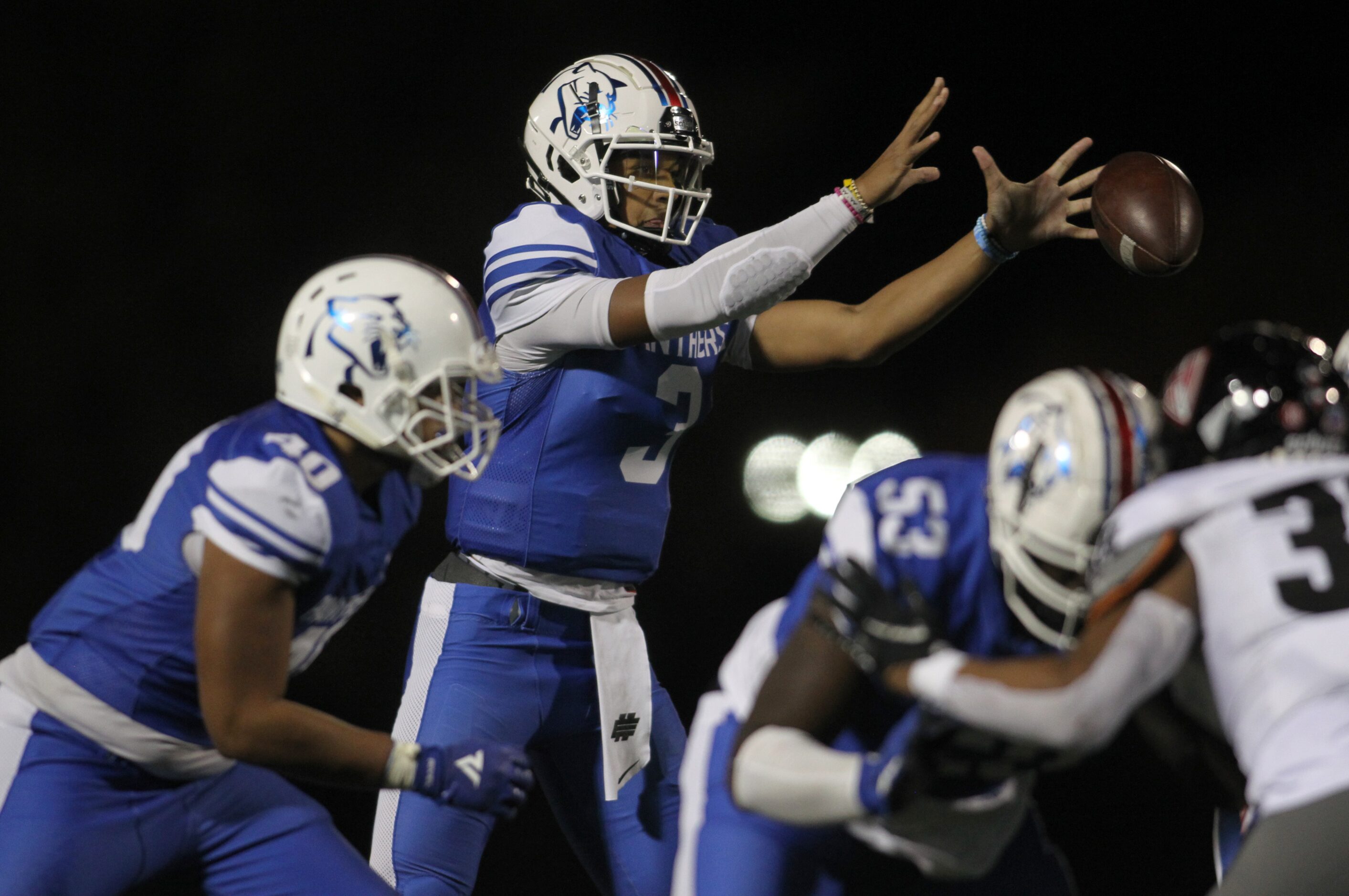 Duncanville quarterback Grayson James (3) reaches for a high snap during first quarter...