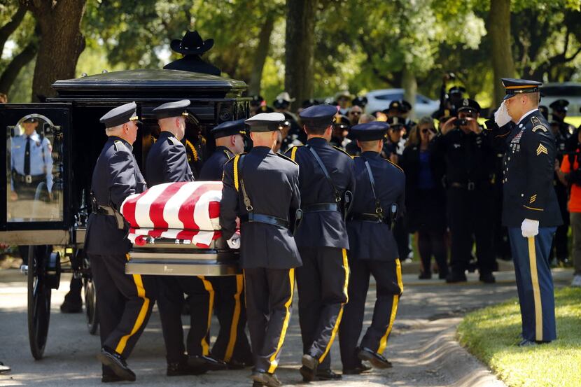Dallas police Honor Guard members carried the flag-draped coffin of slain Dallas police Sgt....