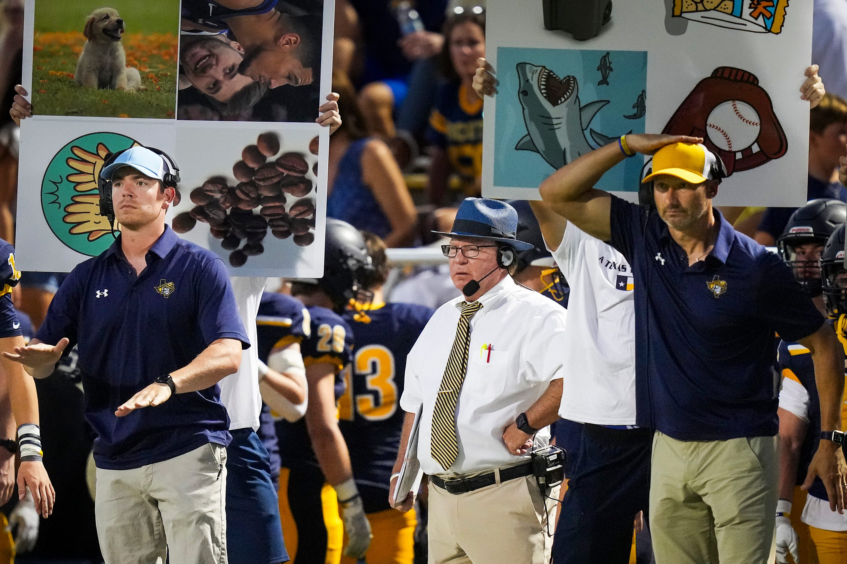 Highland Park head coach Randy Allen looks on as assistants call in a play during the first...