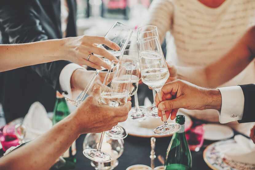 Bubbles and Bites ad photo, people toasting champagne glasses