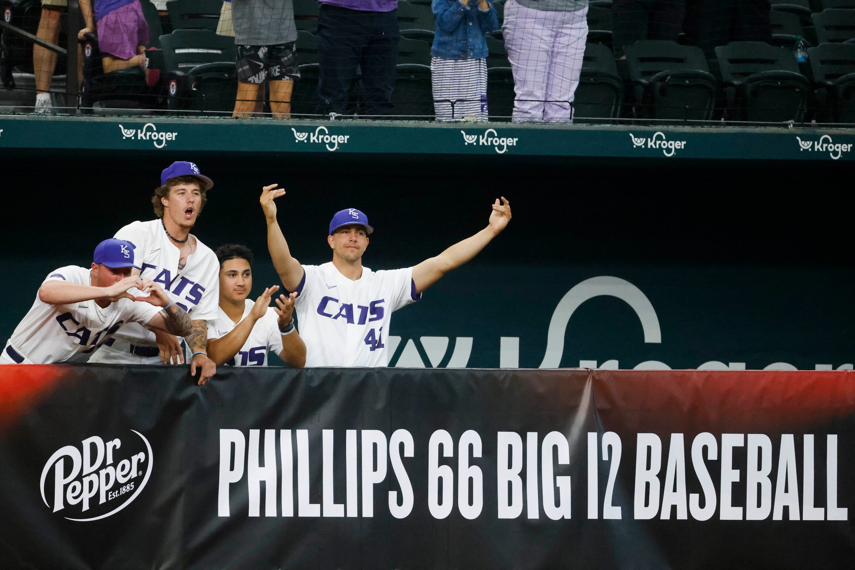 Players cheer after a homer by Kansas St. infielder Kaelen Culpepper during the second...