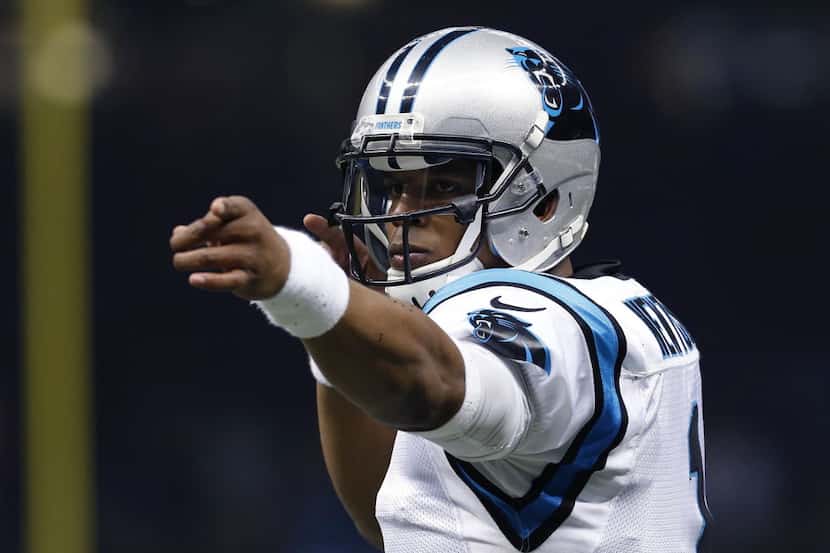 FILE- In this Dec. 6, 2015, file photo, Carolina Panthers quarterback Cam Newton eacts...