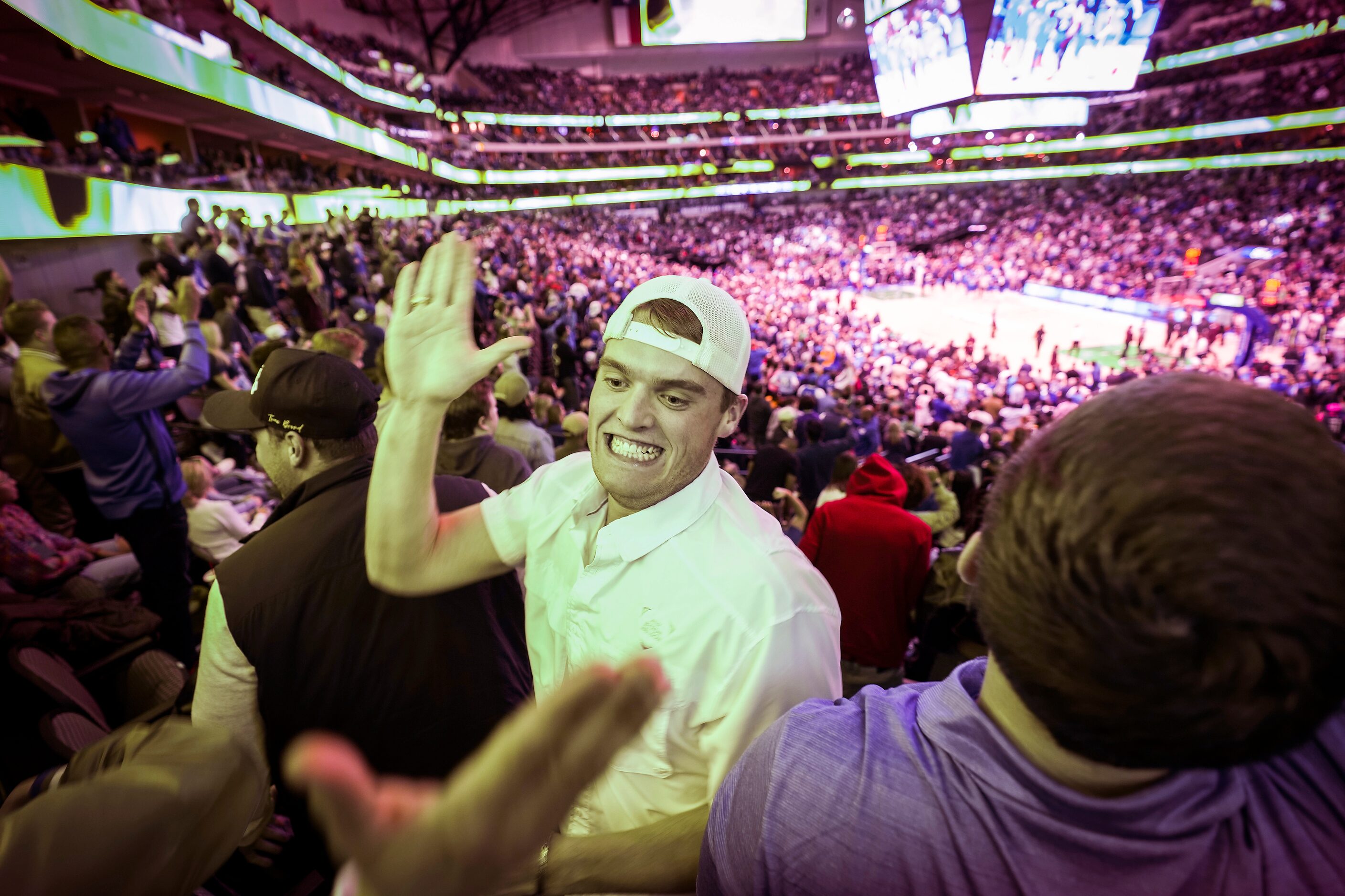 Dallas Mavericks fan  Peyton Steele celebrates with other fans after a 3-pointer by guard...