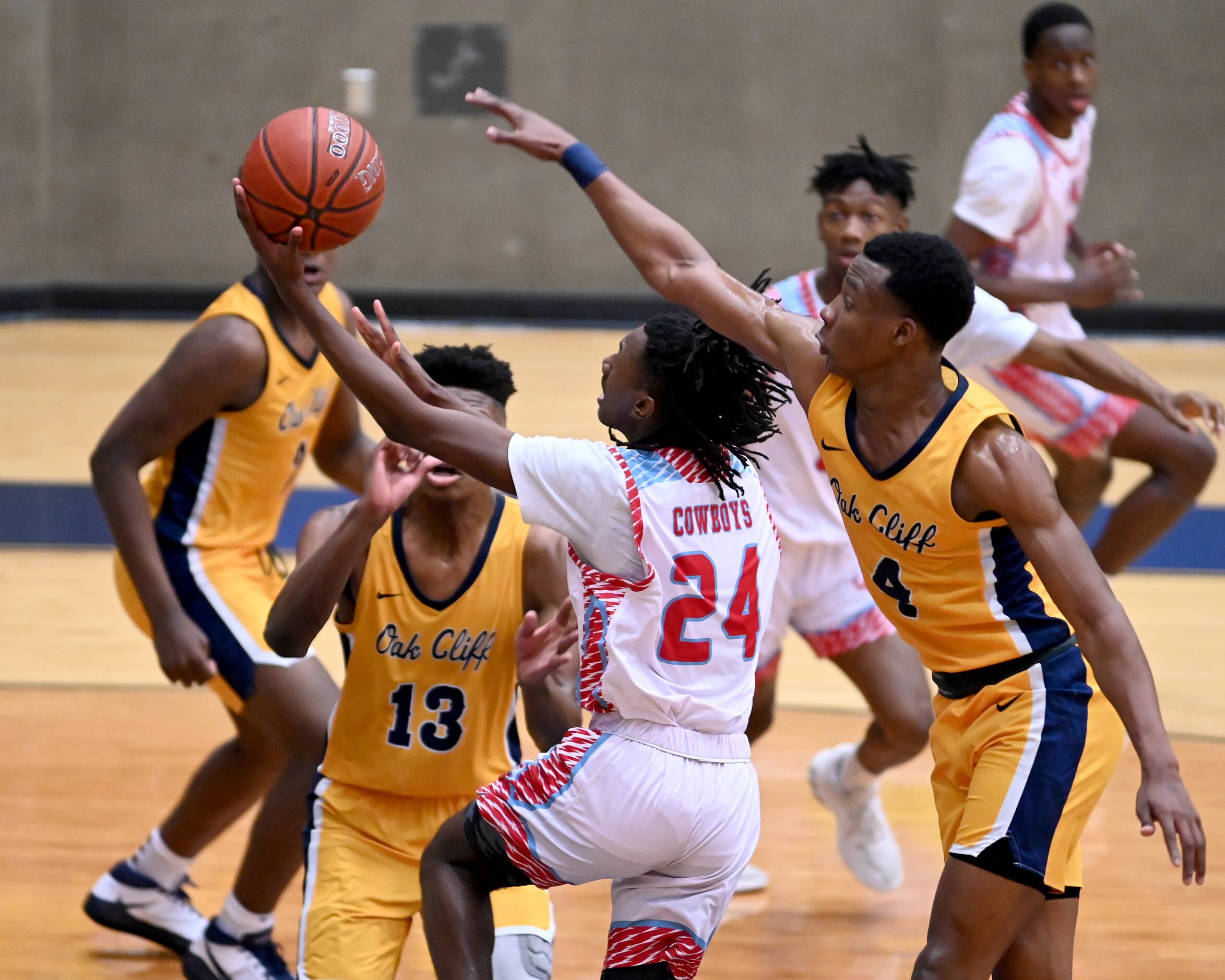 Carter’s Erin Wright (24) drives to the basket in front of Faith Family’s T.J. Caldwell in...