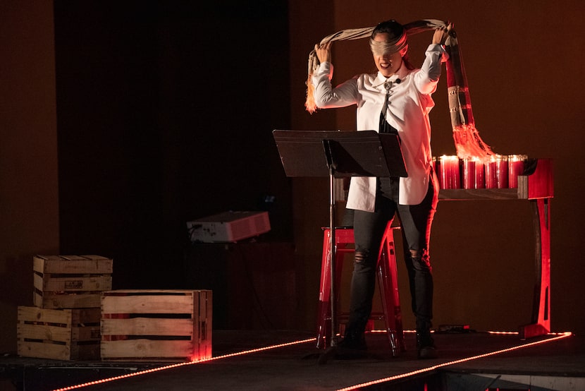 Actress Elena Hurst blindfolds herself during a scene for the world premiere production of...