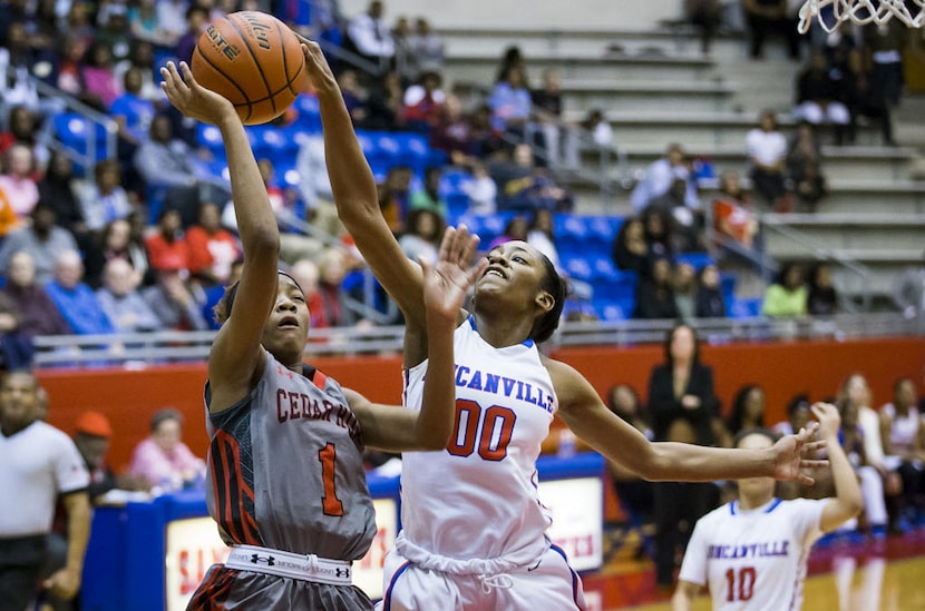 Duncanville forward Zarielle Green (00) blocks a shot by Cedar Hill guard Dajinae Mccarty...