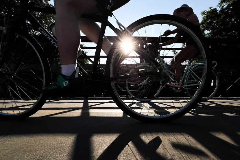 A file photo shows cyclists riding their bikes on the trail at White Rock Lake in Dallas on...