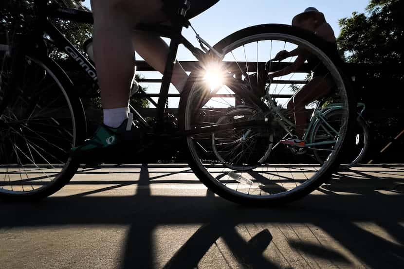Cyclists ride their bikes on the trail at White Rock Lake in Dallas on Tuesday, July 12,...