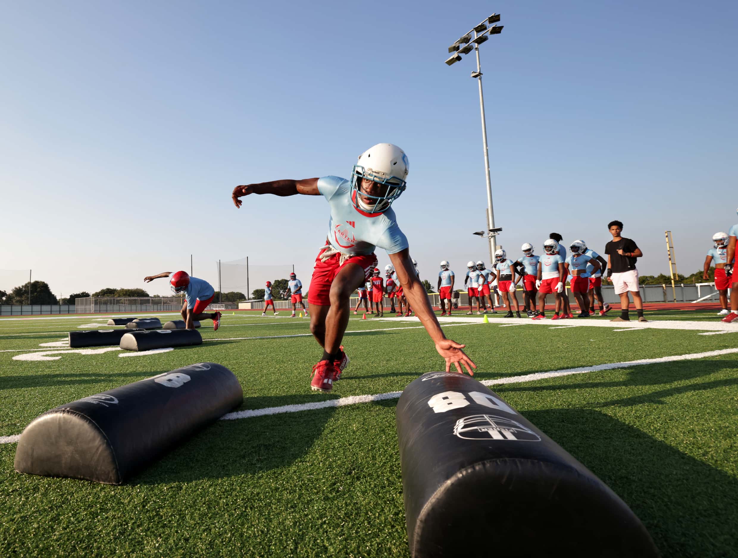 Trent Levingston hones his skills as players attend their first day of football practice at...