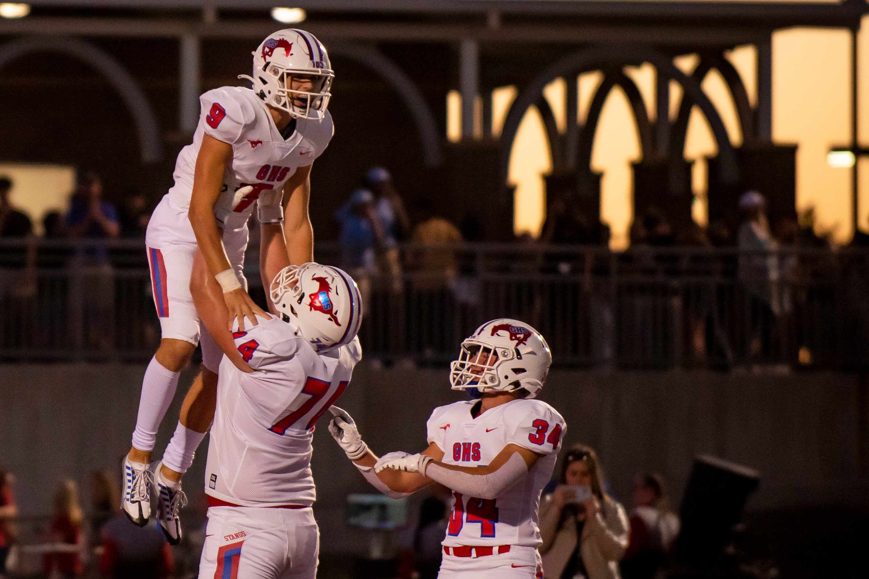 Grapevine senior Evan Baum (9) is hoisted in the air by senior Max Livingston (74) after...