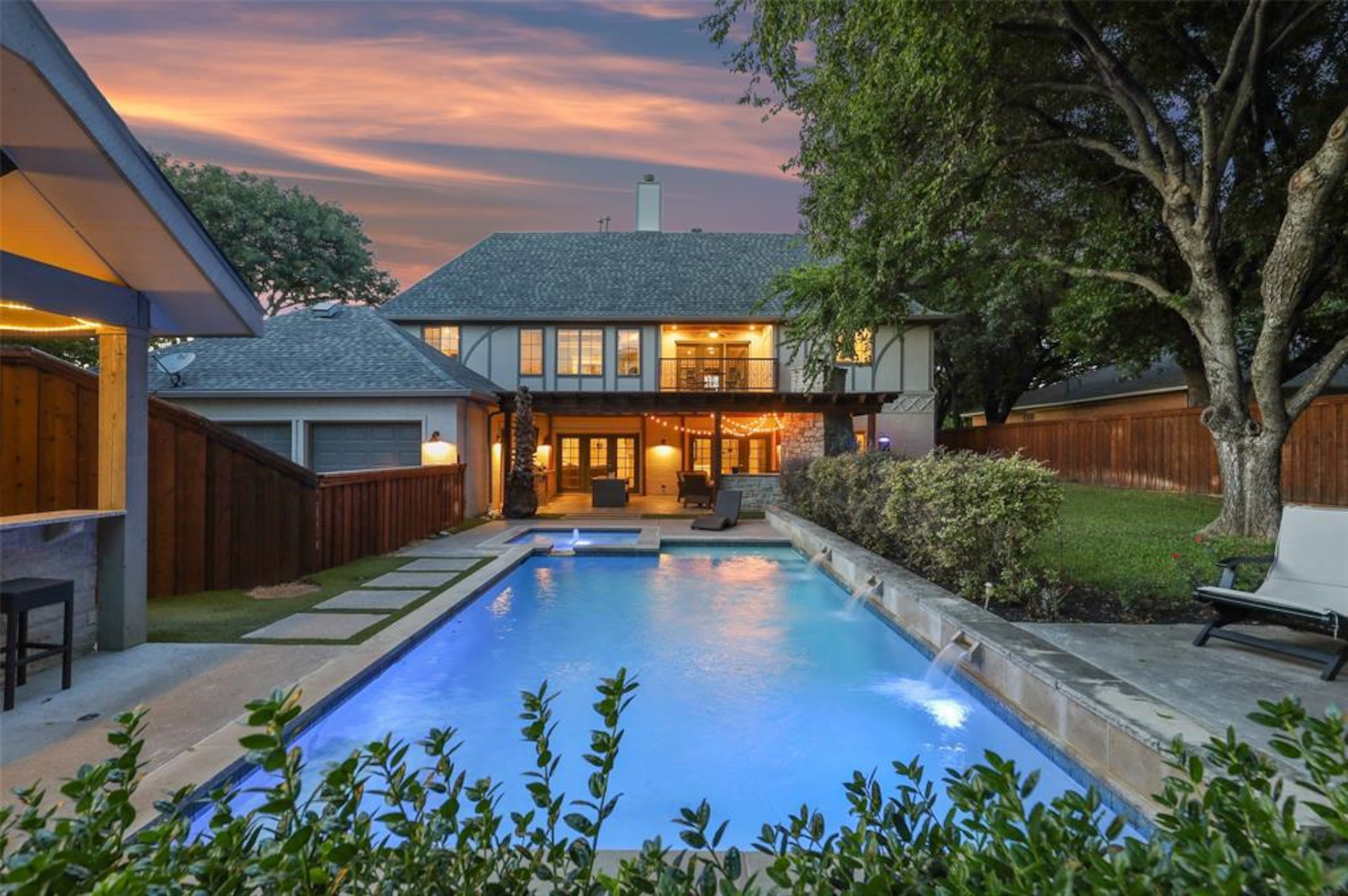 The backyard features a large pool.