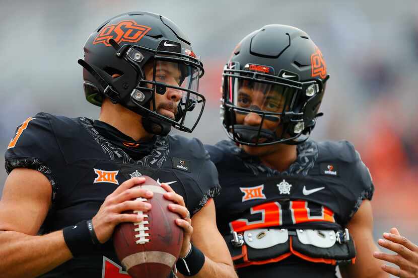 Quarterback Spencer Sanders #3 and running back Chuba Hubbard #30 of the Oklahoma State...