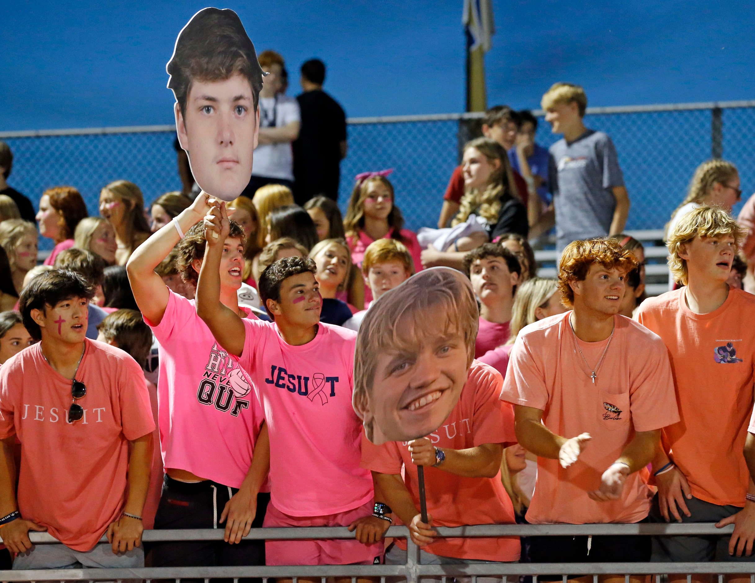 Fans give Jesuit players a heads up from the stands during the first half of a high school...