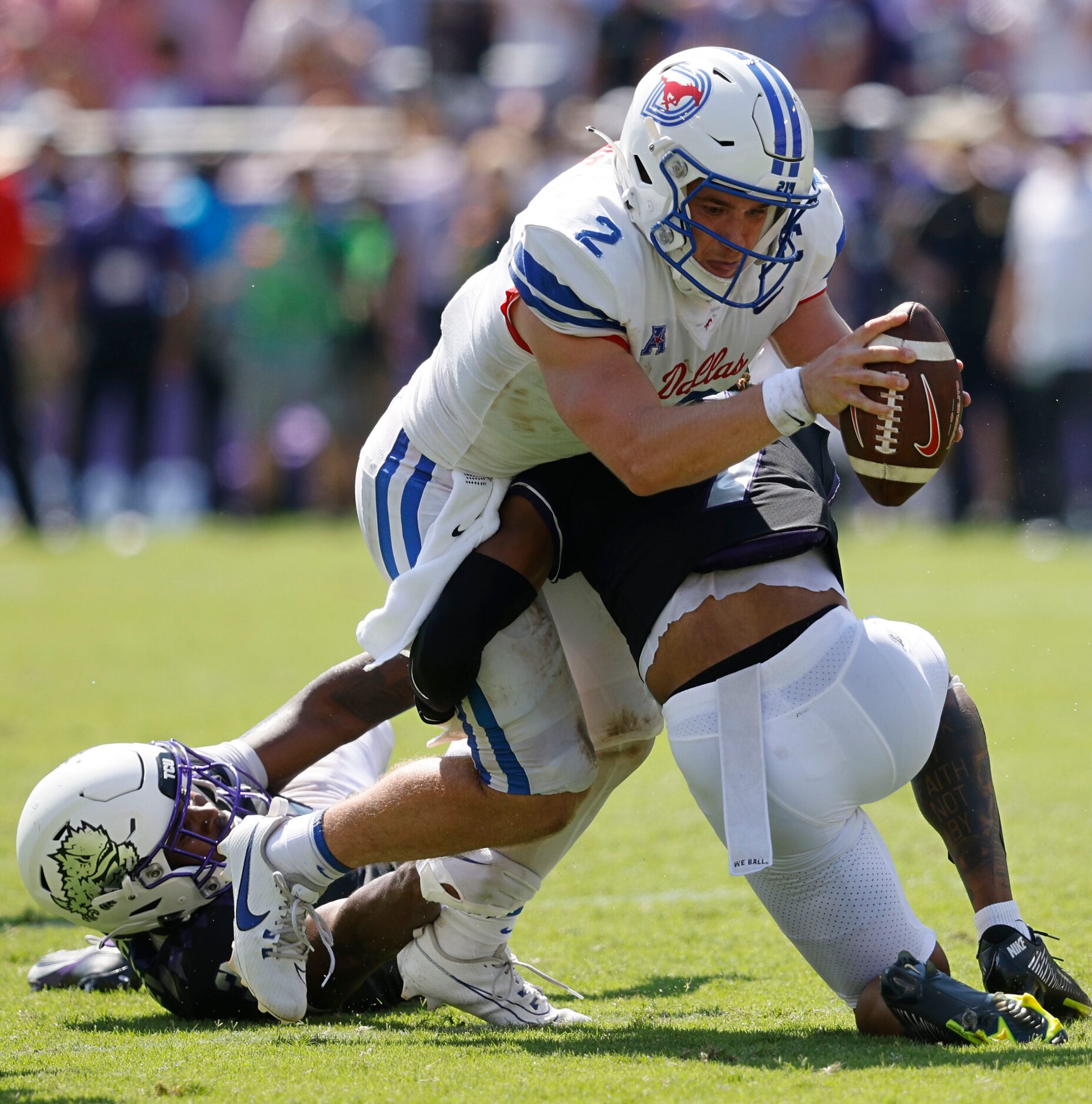 Southern Methodist Mustangs quarterback Preston Stone (2) is tackled by TCU Horned Frogs...