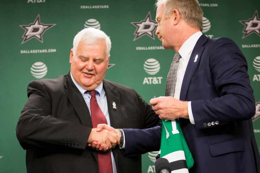 Ken Hitchcock shakes hands with general manager Jim Nill (right) as he is introduced as the...