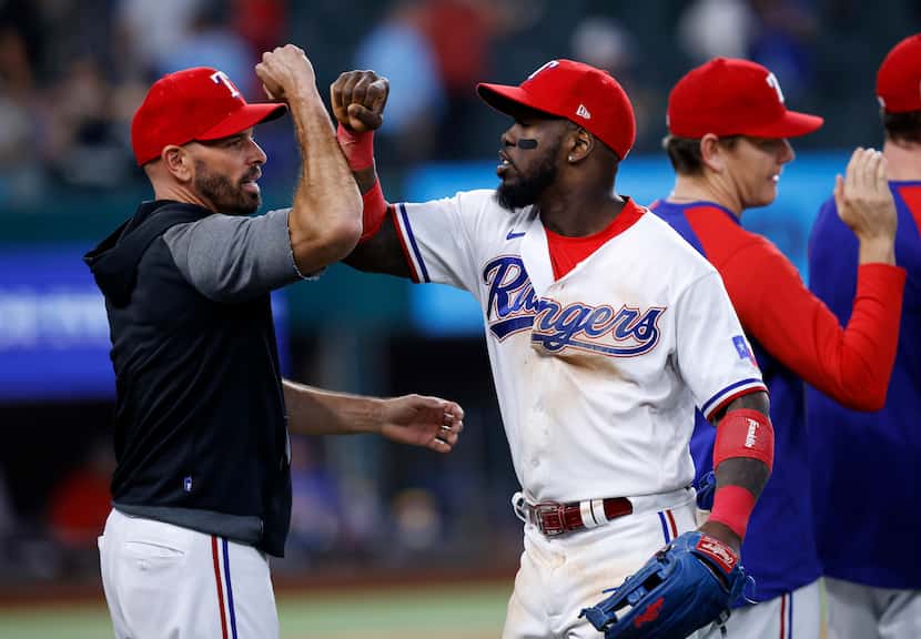 Texas Rangers right fielder Adolis Garcia (53) is congratulated by his manager Chris...