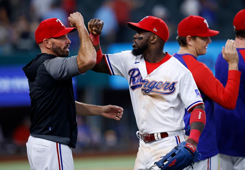 Texas Rangers right fielder Adolis Garcia (53) is congratulated by his manager Chris...