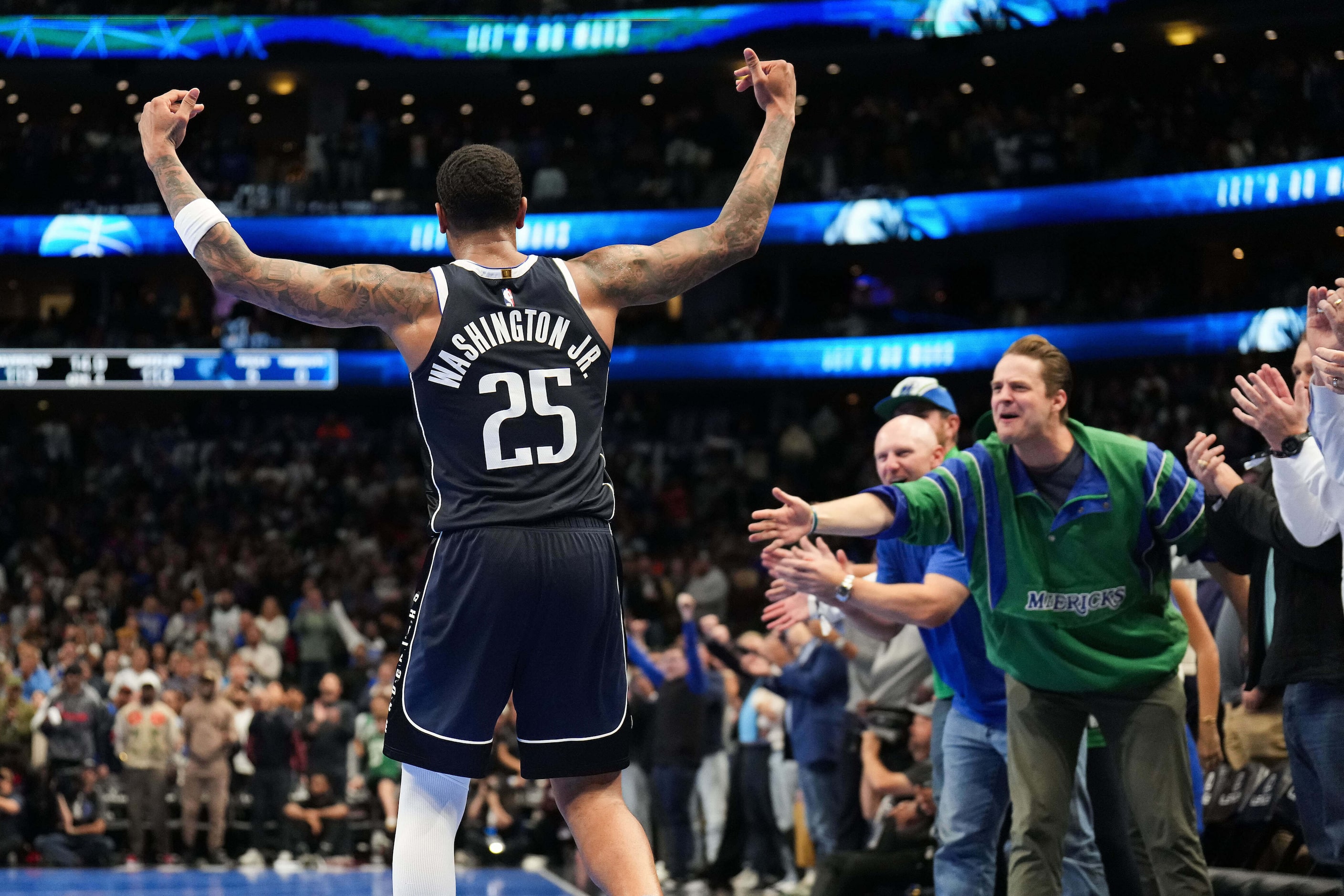 Dallas Mavericks forward P.J. Washington celebrates a late 3-pointer during the second half...