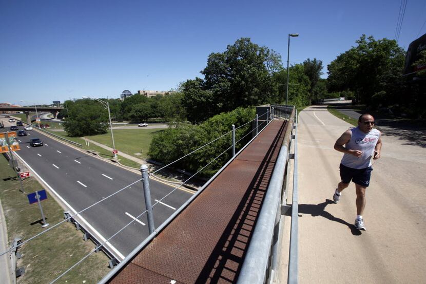 A man jogs the Katy Trail over Harry Hines Boulevard in Dallas. The city of Dallas is...