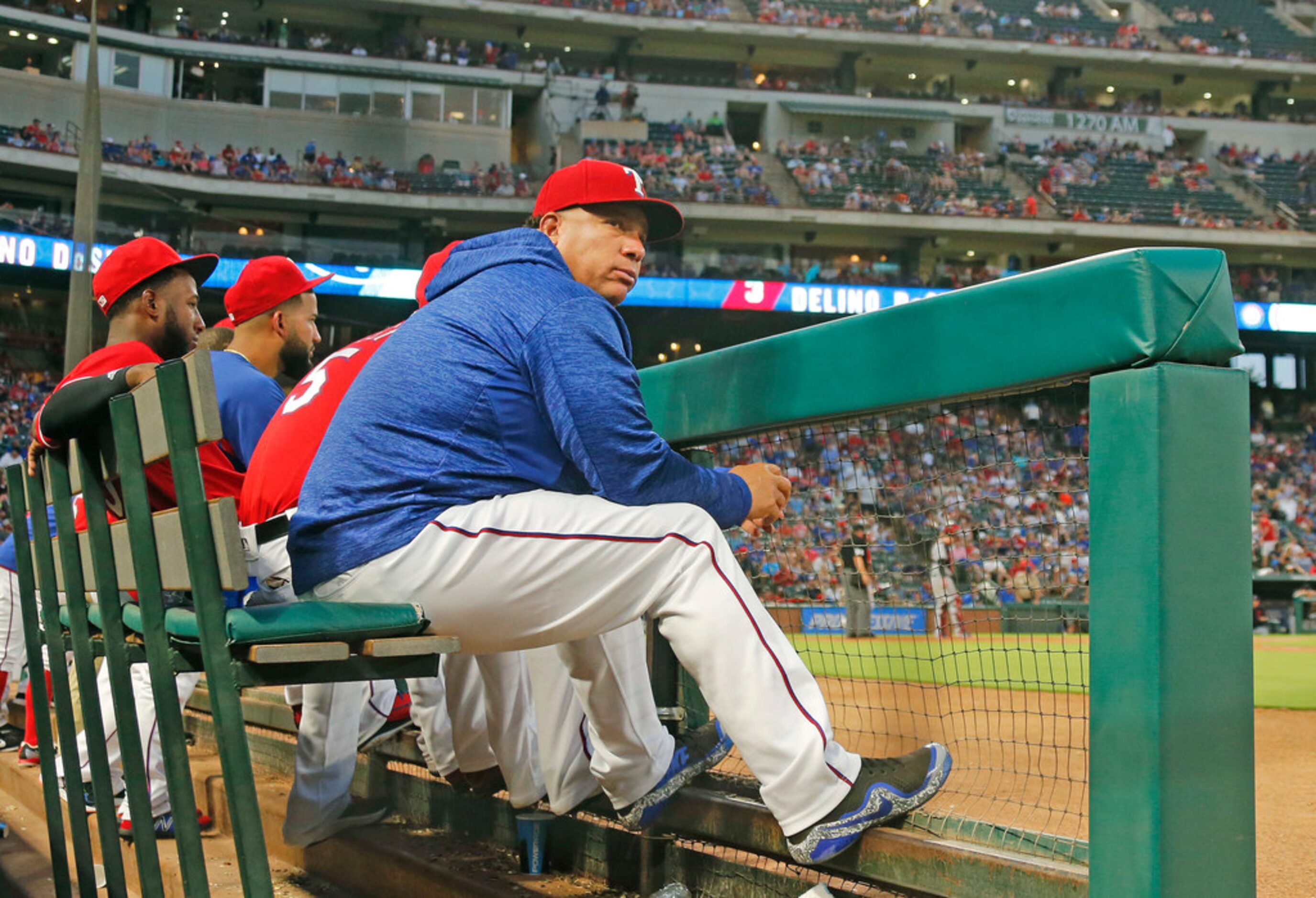 Texas Rangers starting pitcher Bartolo Colon (40) wears a hooded sweatshirt on the bench as...